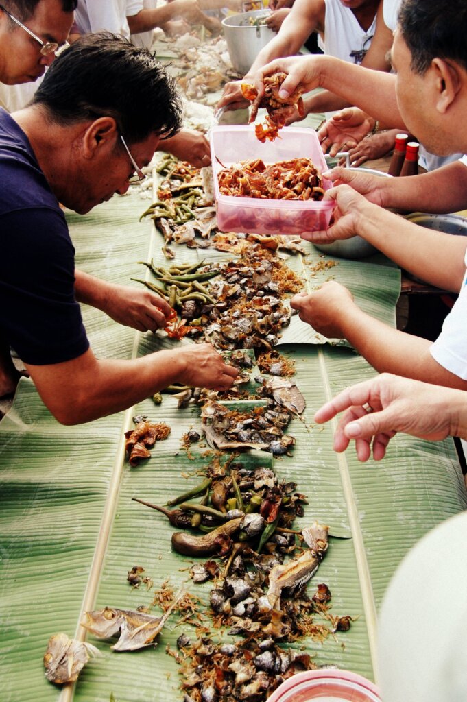 Boodle fight feast laid out on banana leaves