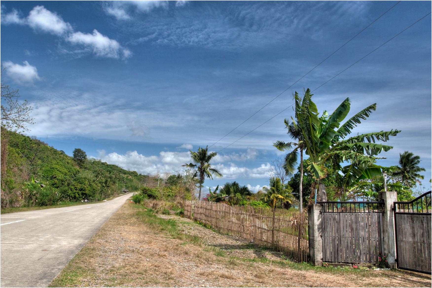 Winding road through green hills on the way to El Nido, Palawan
