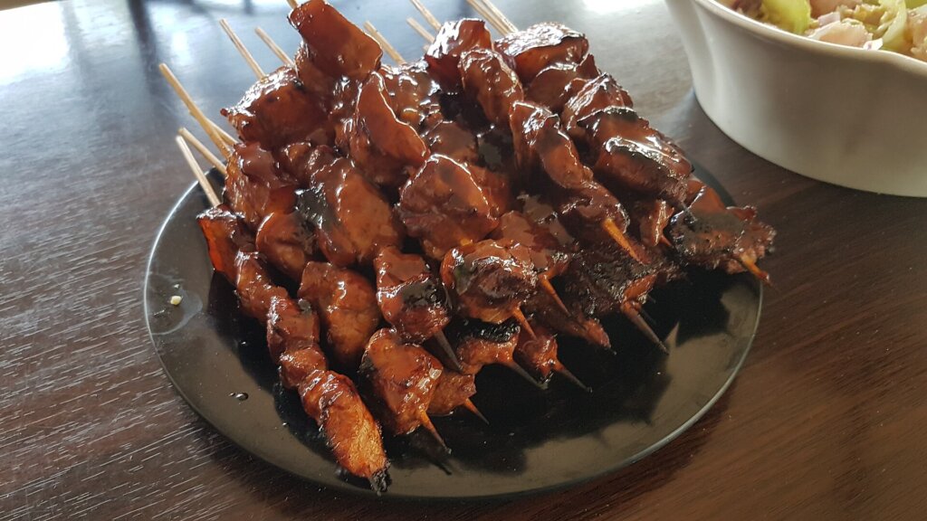 Filipino pork barbecue skewers on the grill