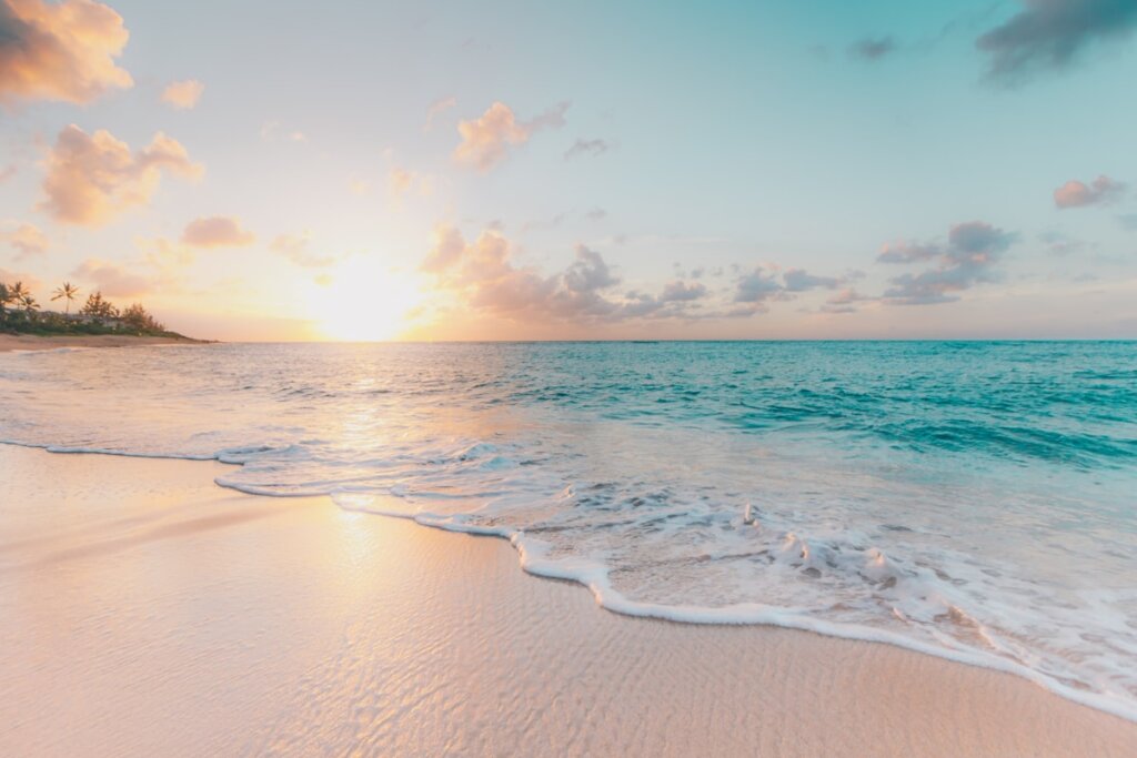 Couple walking on a deserted white sand beach at sunset in El Nido Palawan Philippines