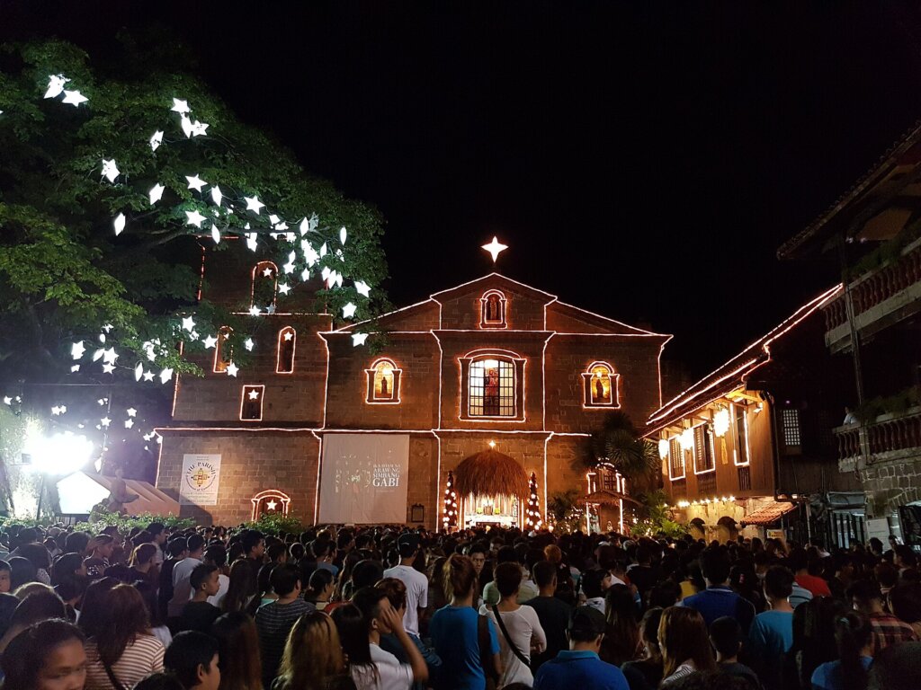 Filipino churchgoers attending a Simbang Gabi dawn mass decorated for Christmas