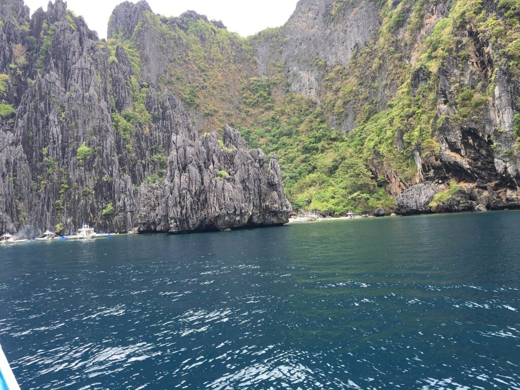 Teens kayaking through a lagoon in El Nido, Palawan