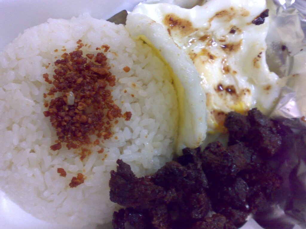 Plate of tapsilog, a classic Filipino breakfast of beef tapa, garlic rice and fried egg