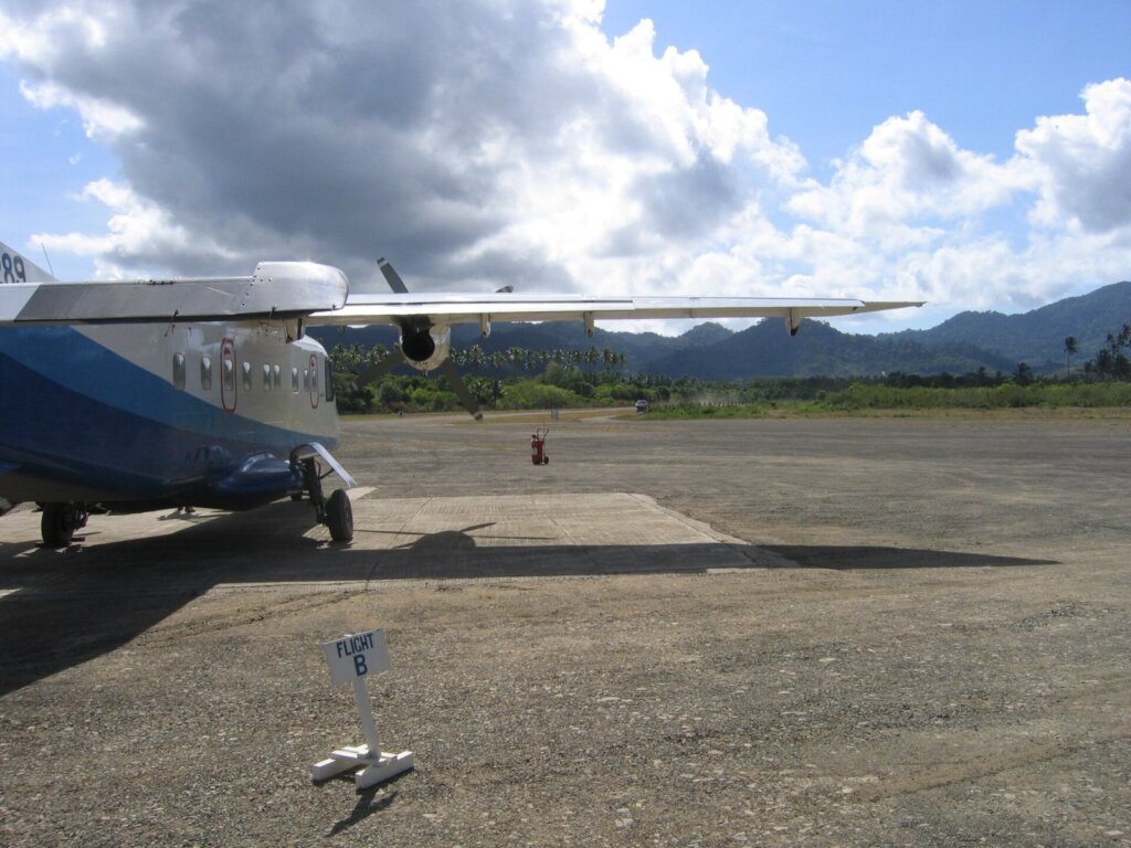 A regional turboprop aircraft on the apron at a small island airport